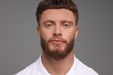 Portrait of handsome man on grey background