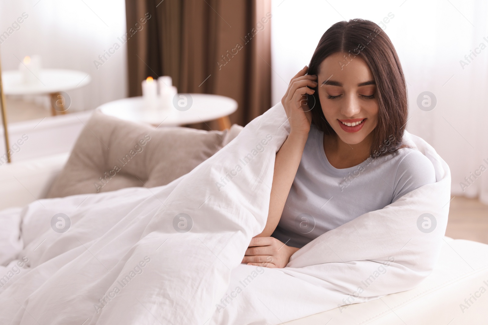 Photo of Woman covered in blanket resting on sofa, space for text