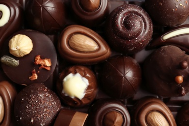 Many different tasty chocolate candies as background