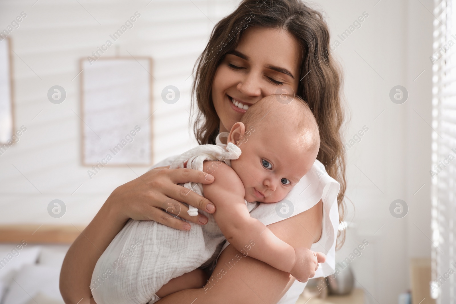 Photo of Happy young mother with her cute baby at home