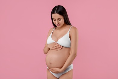 Photo of Beautiful pregnant woman in stylish comfortable underwear on pink background