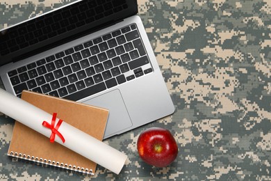 Photo of Notebook, diploma, laptop and apple on camouflage background, flat lay with space for text. Military education