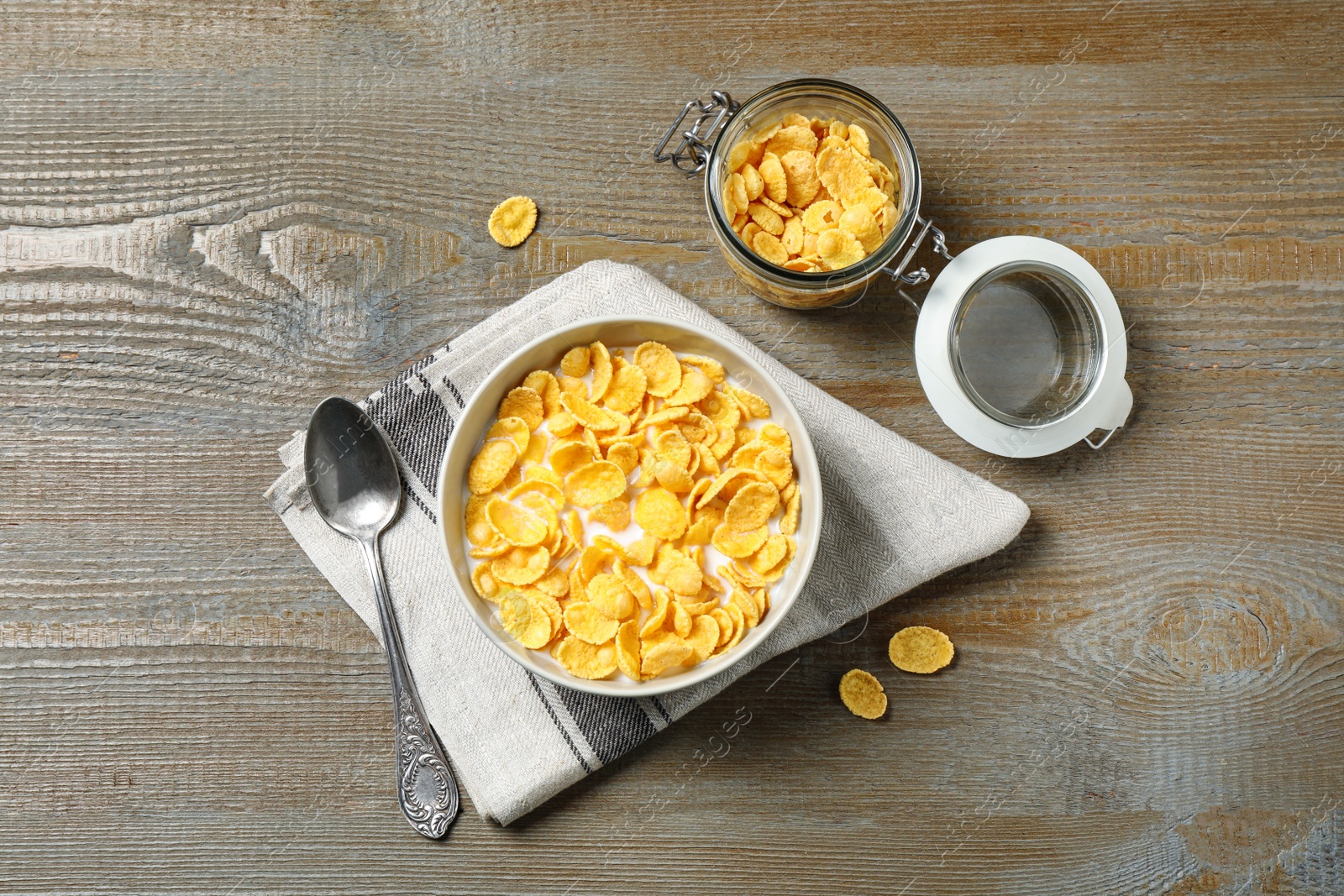 Photo of Flat lay composition with tasty corn flakes on wooden table