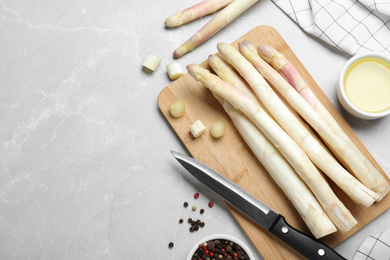 Photo of Flat lay composition with white asparagus on grey marble table. Space for text