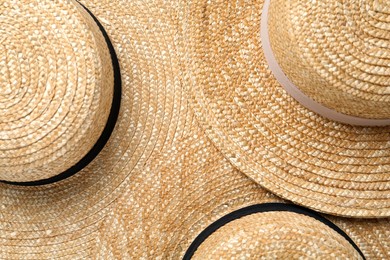 Photo of Many different straw hats as background, top view