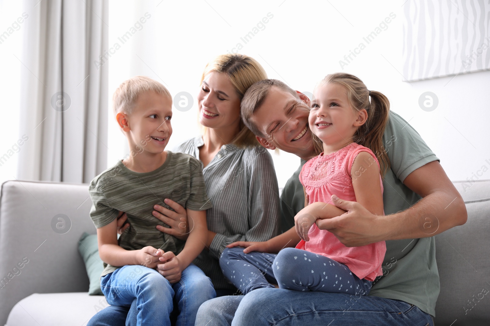 Photo of Happy family with children on sofa at home