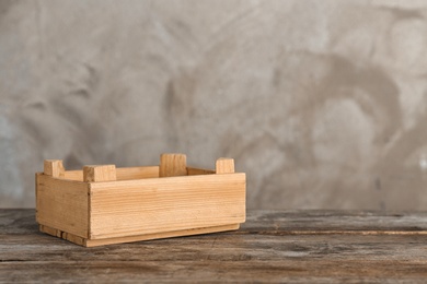 Photo of Wooden crate on table against color background. Space for text