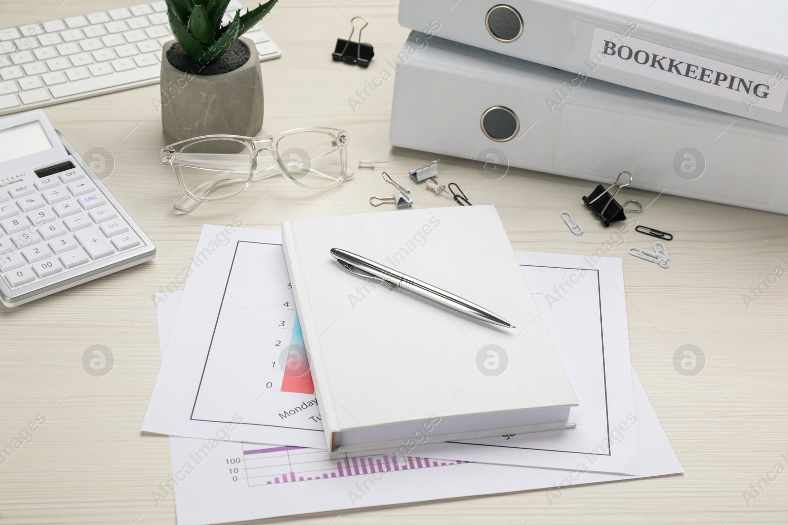 Photo of Bookkeeper's workplace with folders and documents on table