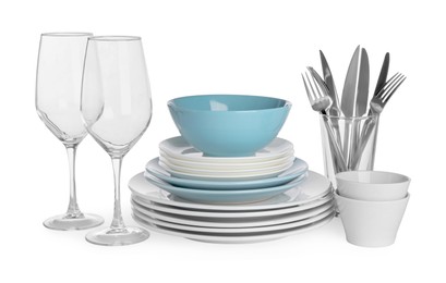 Photo of Set of beautiful ceramic dishware, glasses and cutlery isolated on white