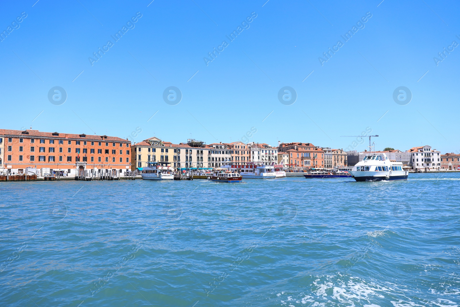 Photo of VENICE, ITALY - JUNE 13, 2019: Picturesque view of city on sea shore and boats