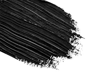 Photo of Brushstrokes of black oil paint on white background, closeup