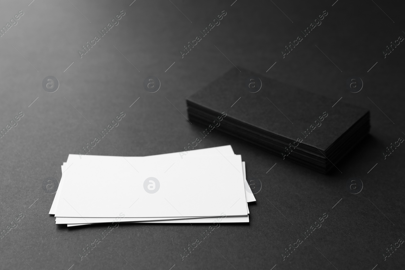 Photo of Blank business cards on black background. Mockup for design