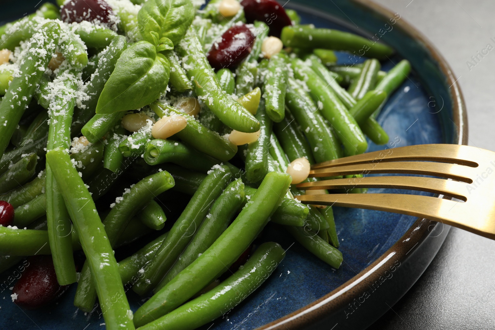 Photo of Tasty salad with green beans served on grey table, closeup