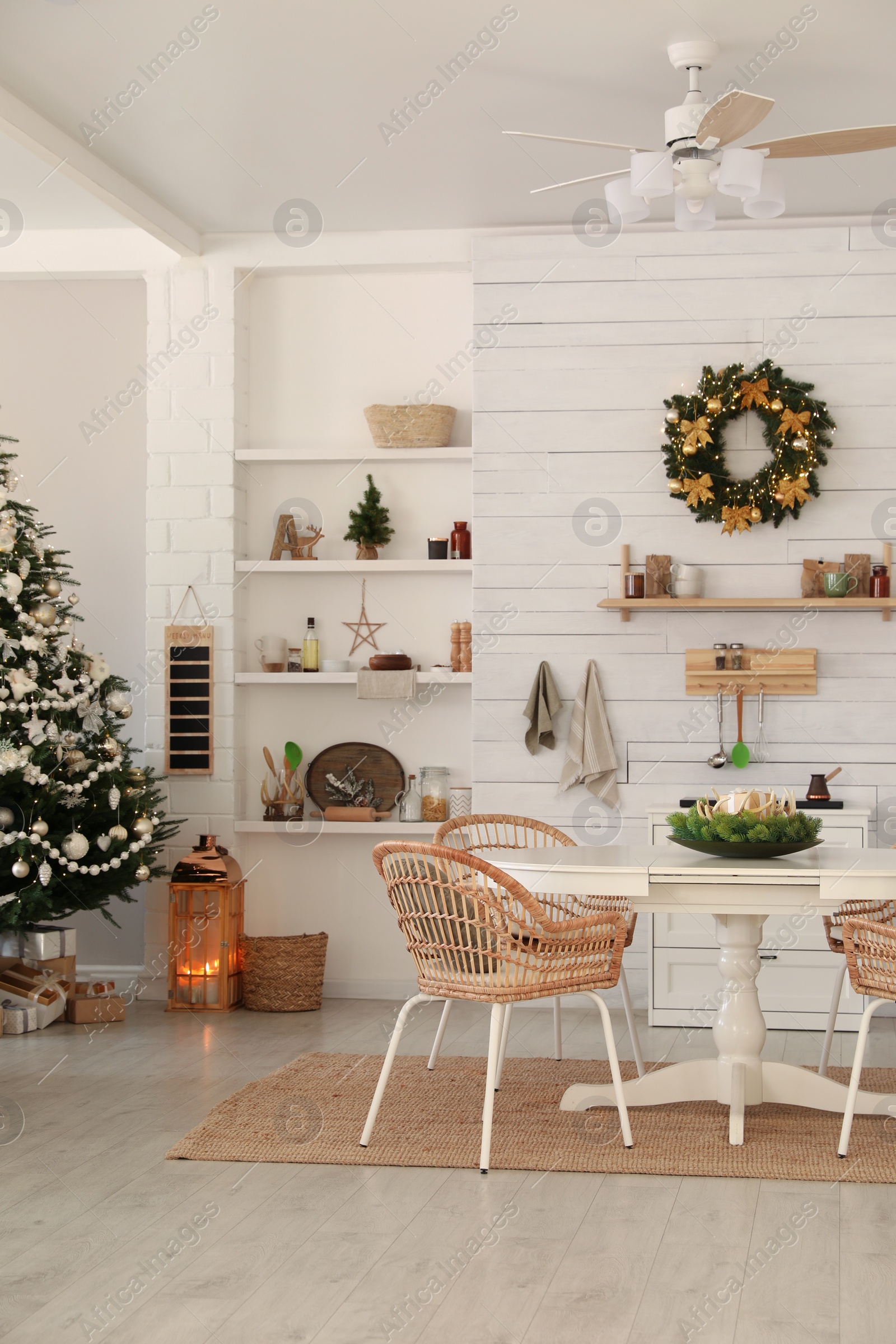 Photo of Cozy dining room interior with Christmas tree and festive decor