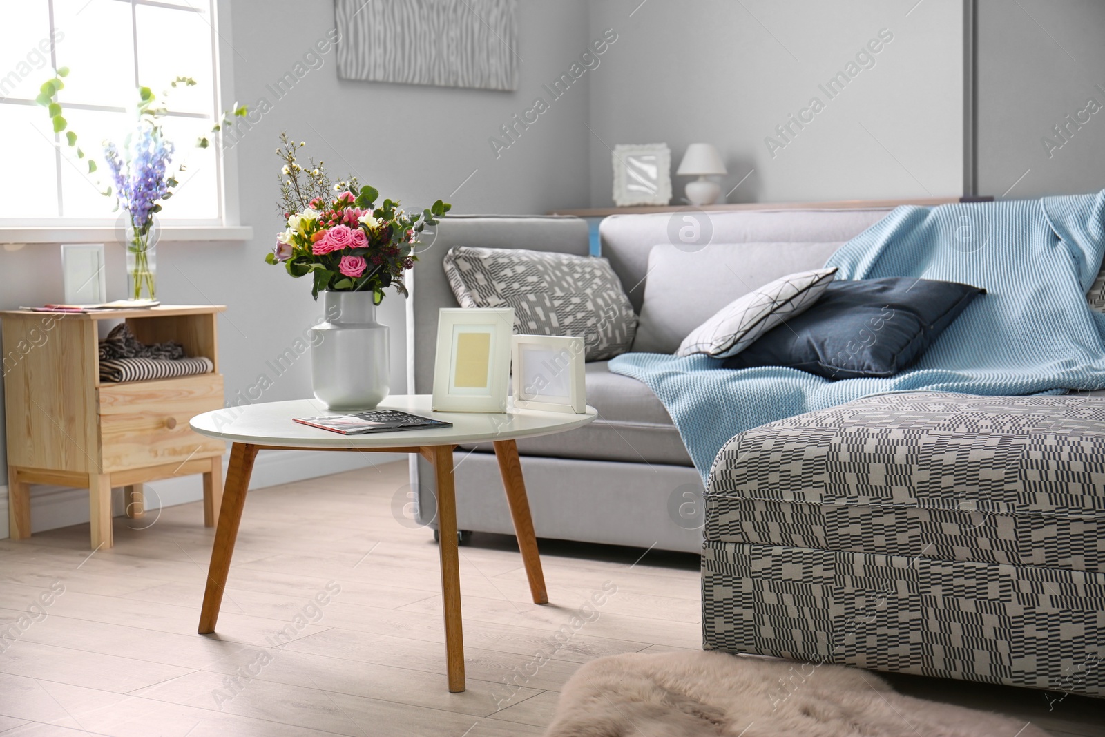 Photo of Cozy living room interior with comfortable sofa and elegant table