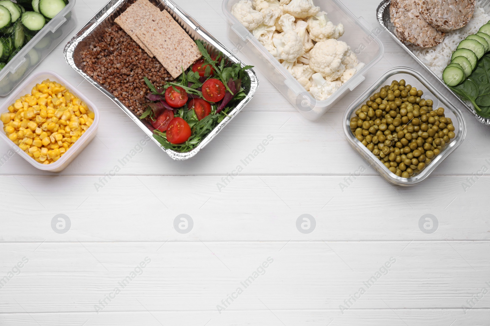 Photo of Different containers with fresh products on white wooden table, flat lay. Space for text