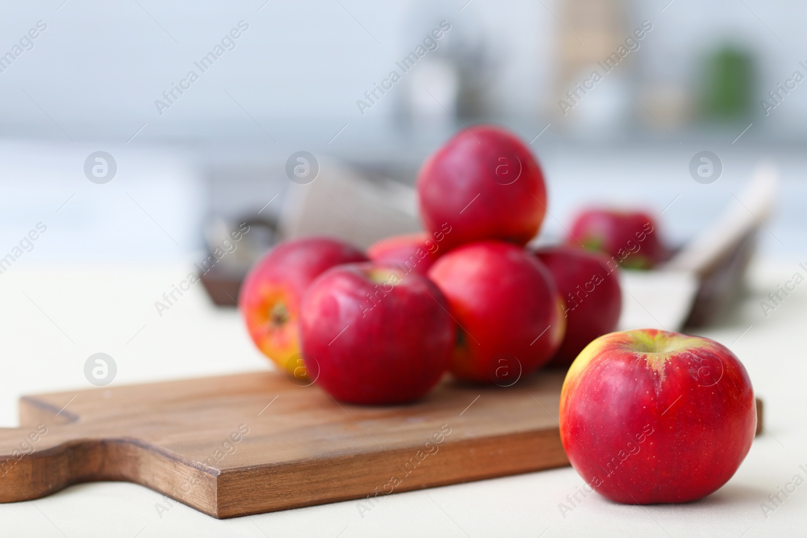 Photo of Ripe red apples on wooden board