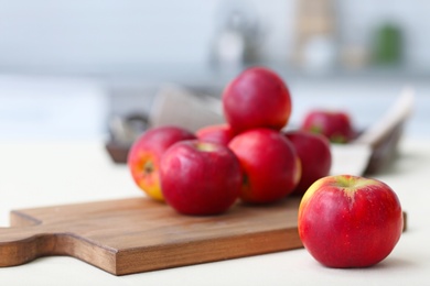 Photo of Ripe red apples on wooden board