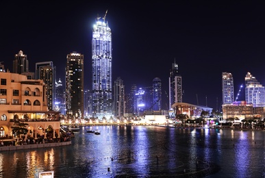 Photo of DUBAI, UNITED ARAB EMIRATES - NOVEMBER 04, 2018: Beautiful night cityscape with Burj Khalifa lake at Downtown Dubai
