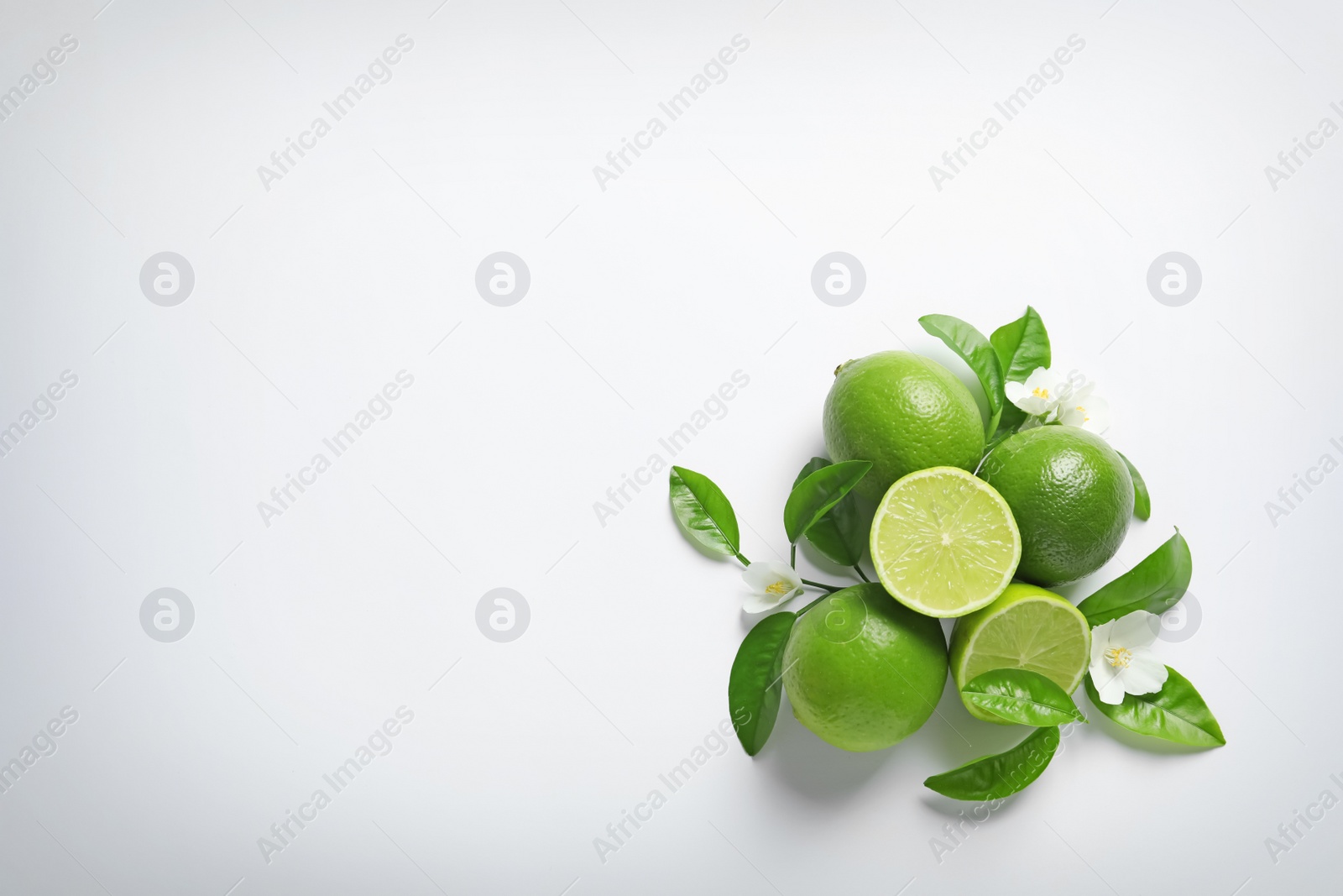 Photo of Composition with fresh ripe limes on white background, top view