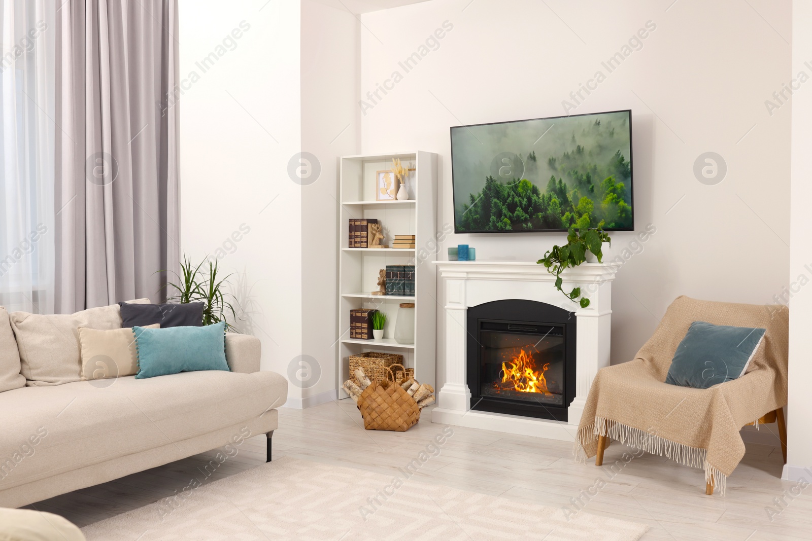 Photo of Stylish living room interior with cozy sofa, TV set and fireplace