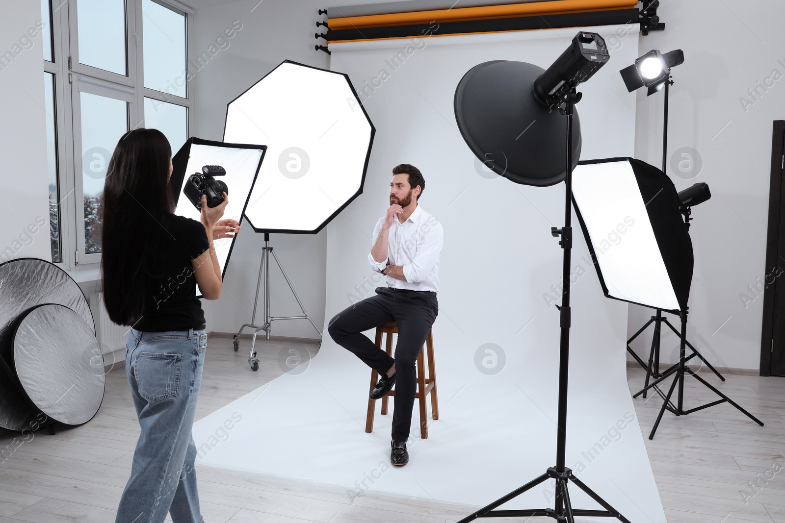 Photo of Handsome model posing for professional photographer in studio