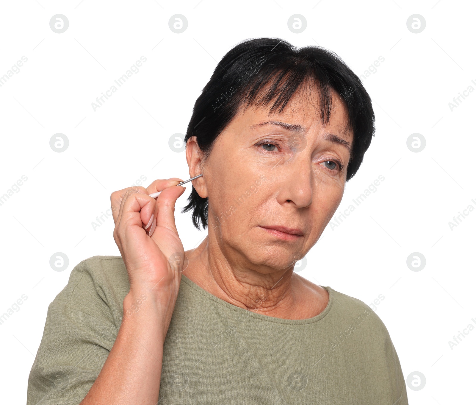 Photo of Senior woman cleaning ear with cotton swab on white background