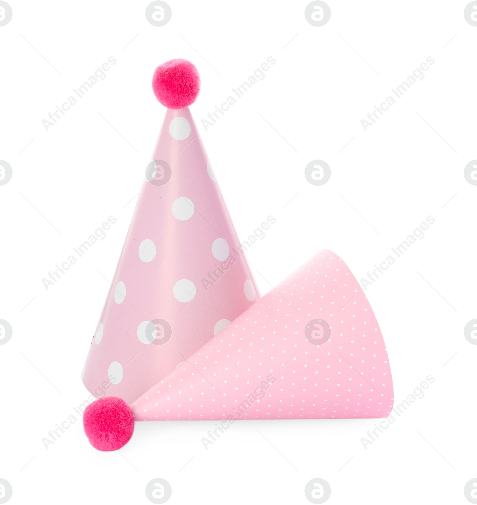 Photo of Two pink party hats with pompoms isolated on white