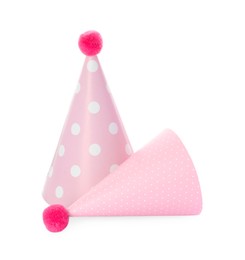 Photo of Two pink party hats with pompoms isolated on white