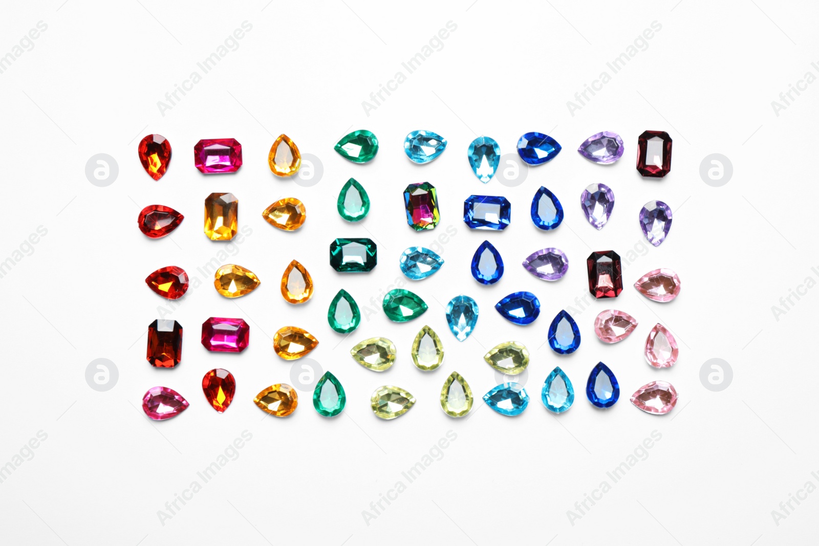 Photo of Different beautiful gemstones on white background, top view