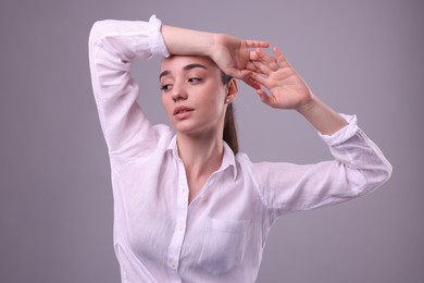 Photo of Portrait of beautiful young woman posing on light grey background