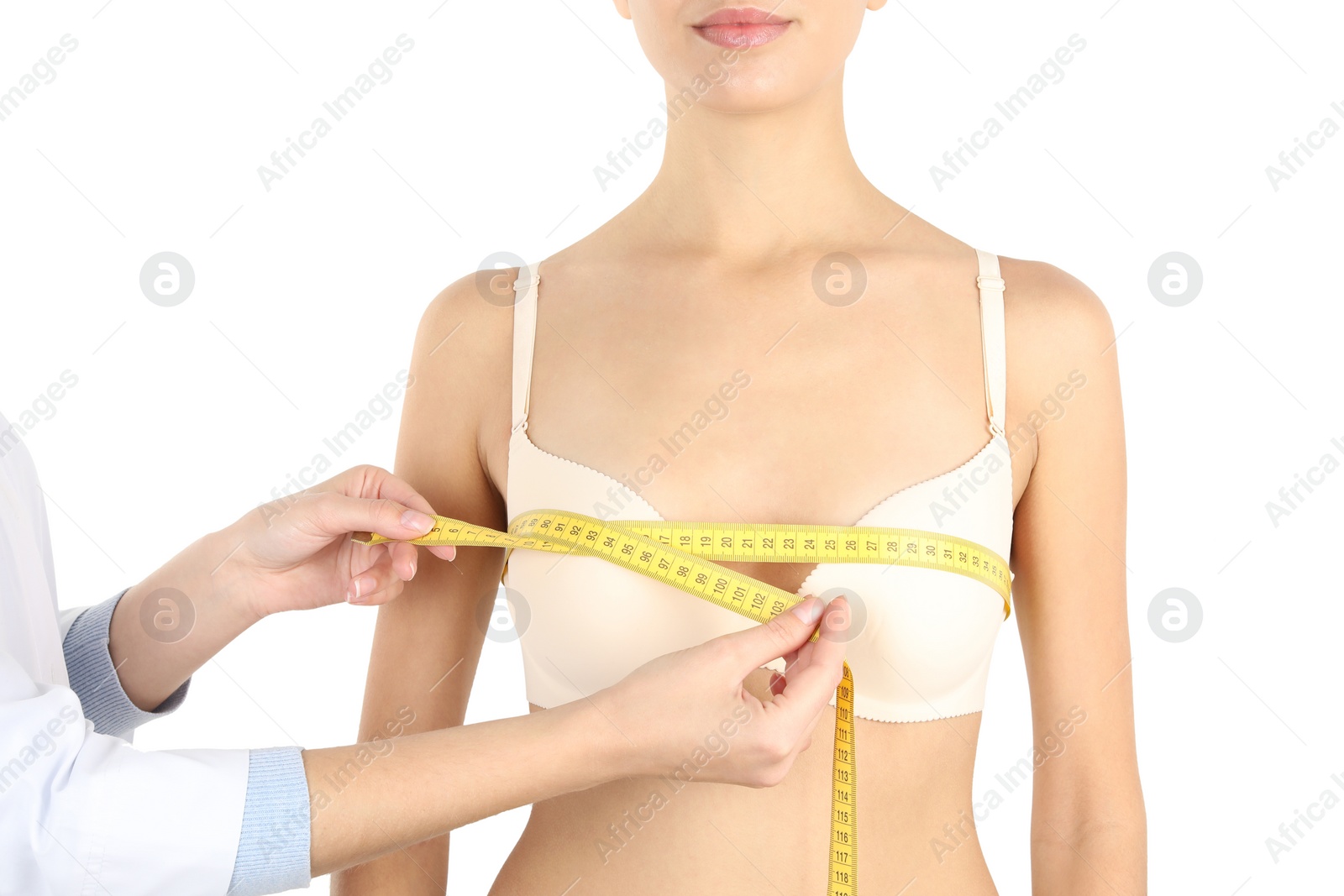 Photo of Doctor measuring size of patient's breast on white background, closeup. Cosmetic surgery