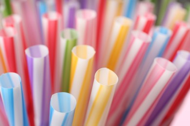 Heap of colorful plastic straws for drinks as background, closeup