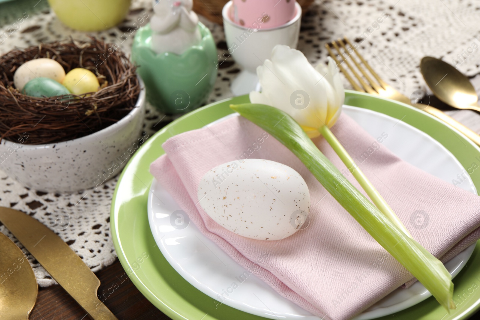 Photo of Festive table setting with beautiful tulip, closeup. Easter celebration