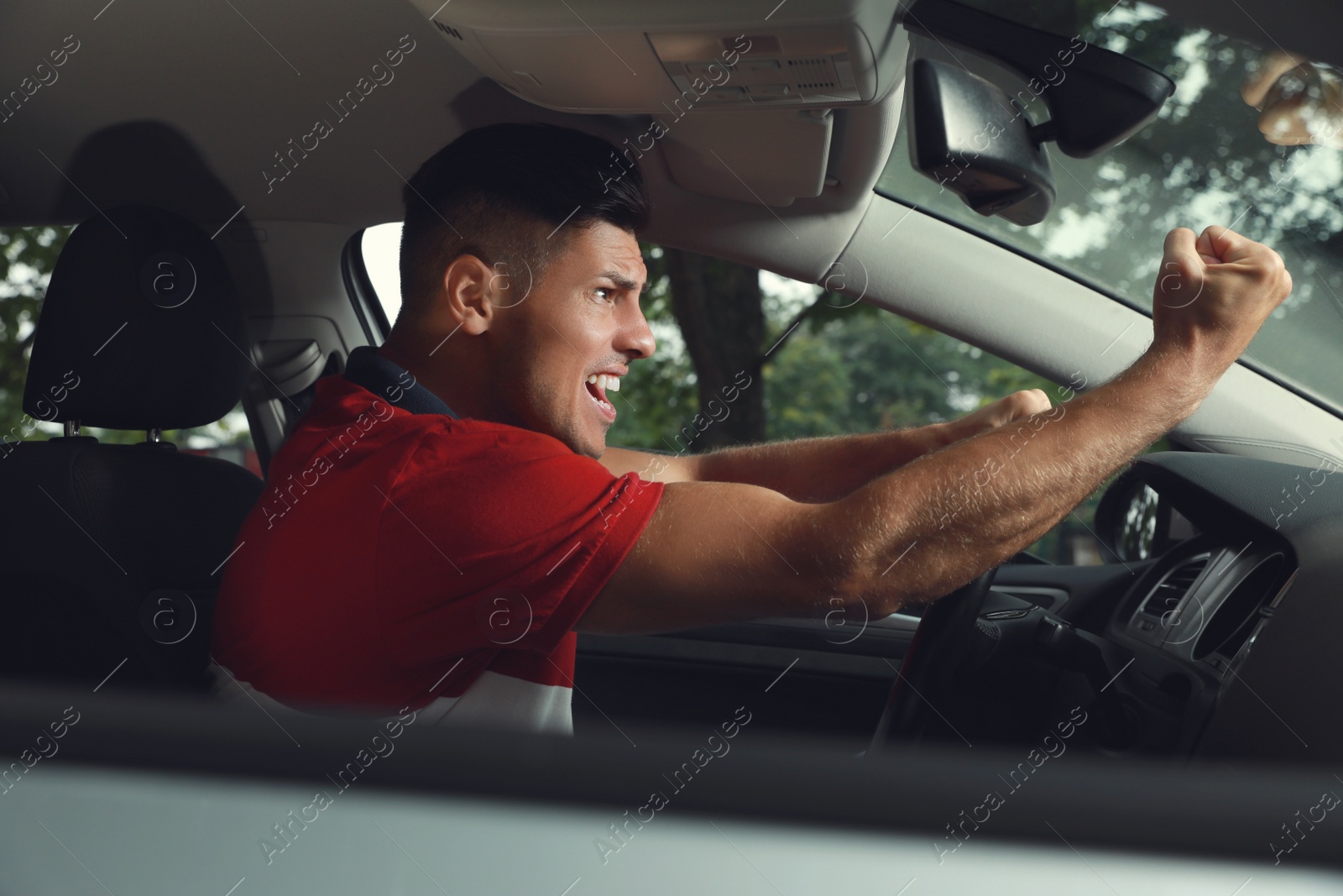 Photo of Stressed man in driver's seat of modern car