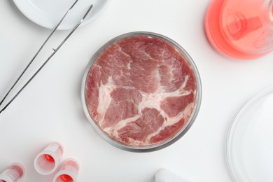 Photo of Sample of cultured meat on white lab table, flat lay