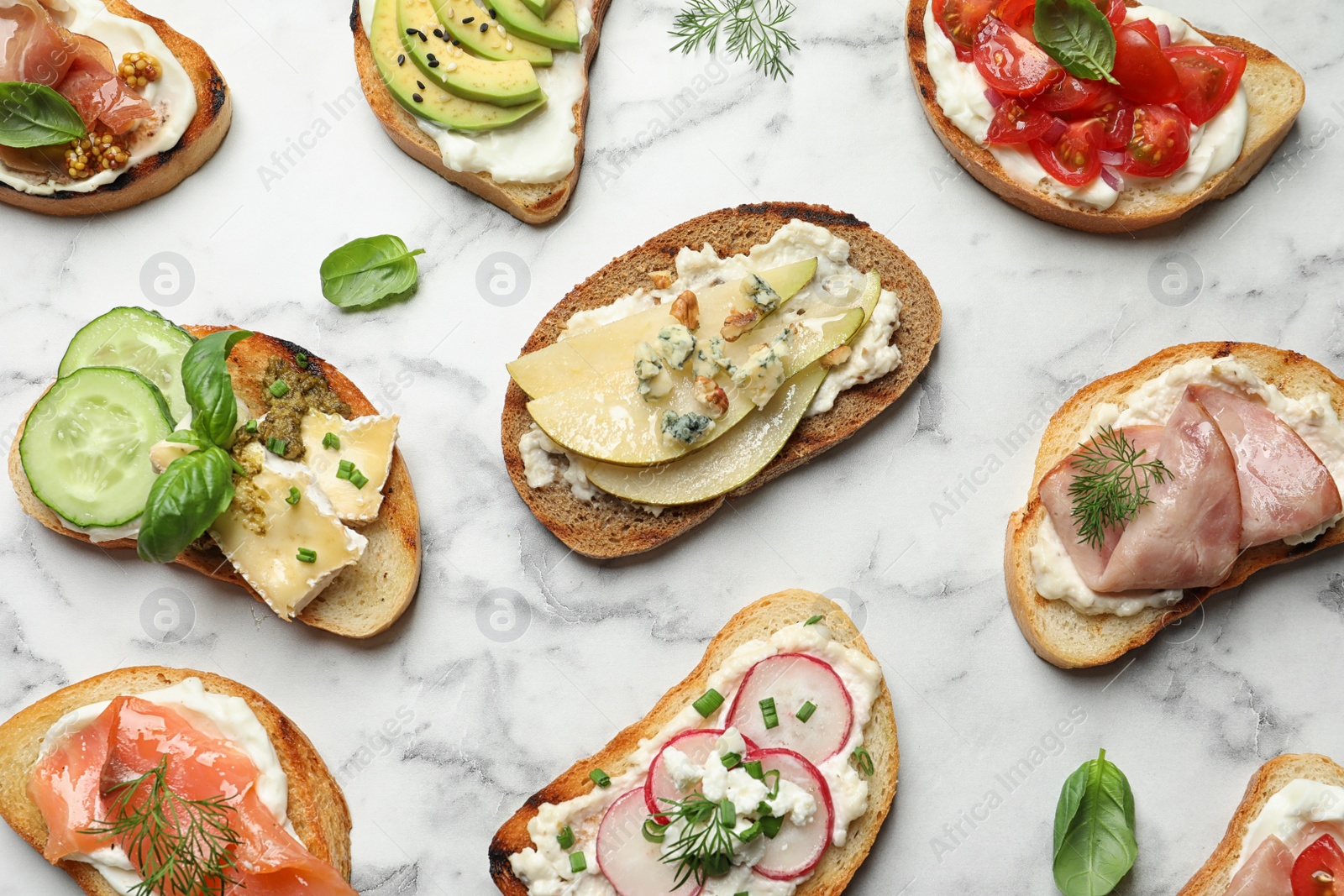 Photo of Different tasty bruschettas on marble background, flat lay