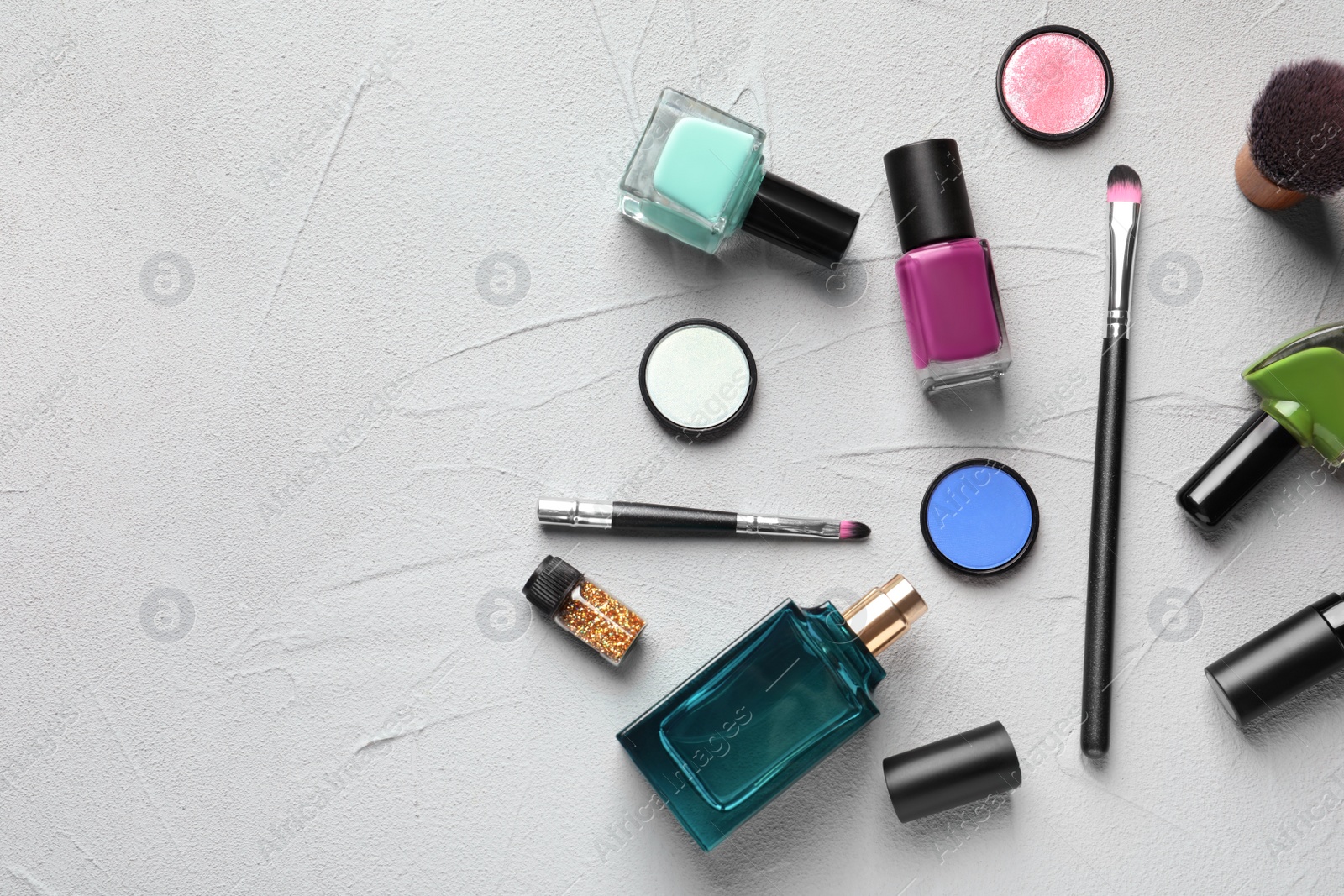 Photo of Flat lay composition with decorative cosmetics on gray background