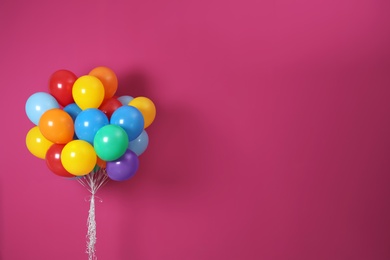 Photo of Bunch of bright balloons and space for text against color background