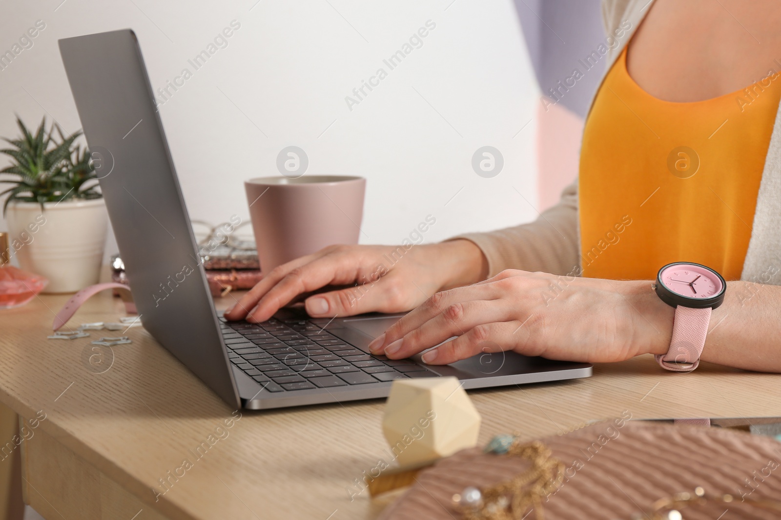 Photo of Woman using laptop at desk, closeup. Beauty blogger