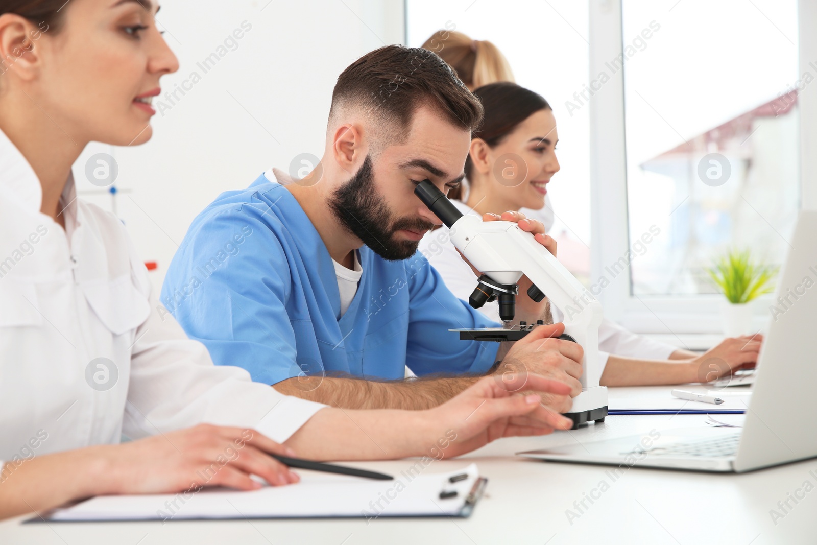 Photo of Medical students working in modern scientific laboratory