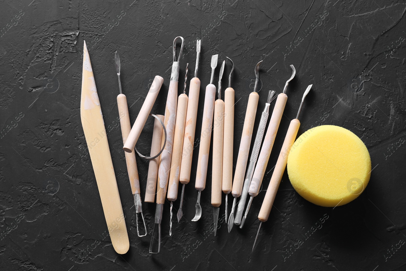 Photo of Set of different clay crafting tools and pottery sponge