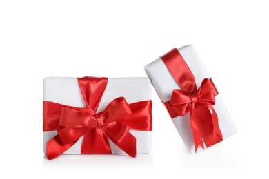 Photo of Beautifully wrapped gift boxes on white background