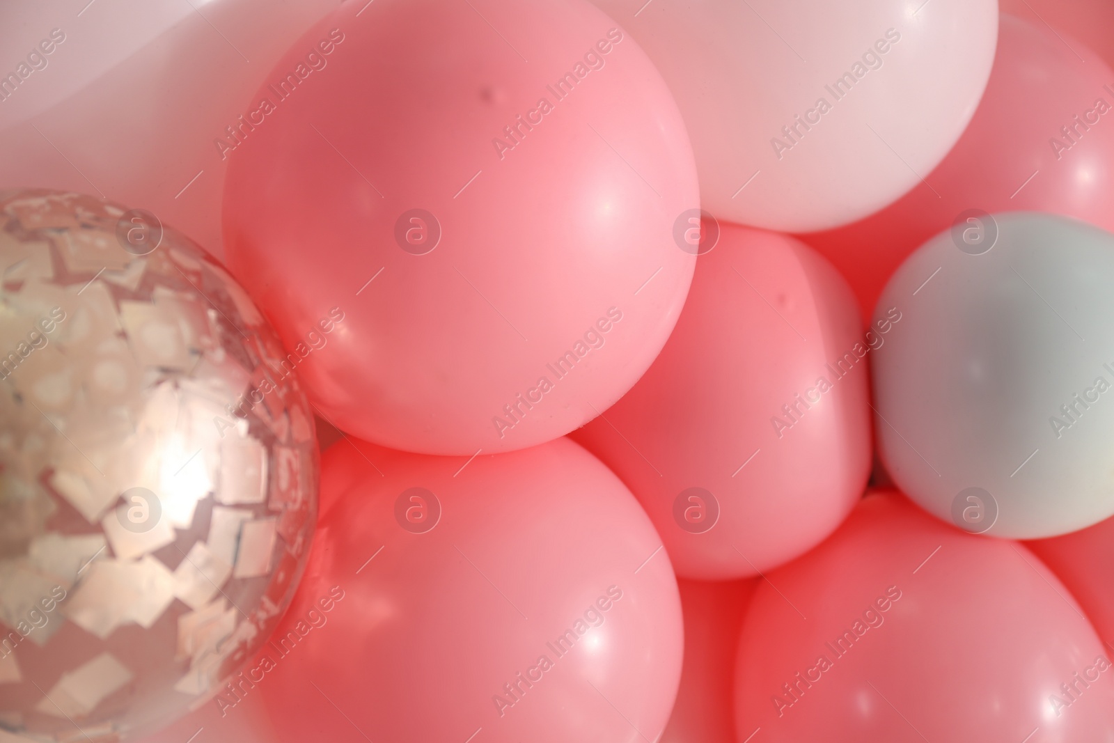 Photo of Beautiful colorful balloons on light background, closeup