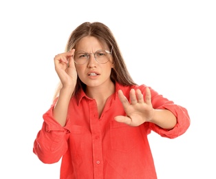 Photo of Young woman with vision problems wearing glasses on white background
