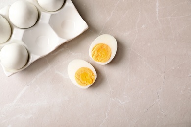 Flat lay composition with boiled eggs and space for text on gray background