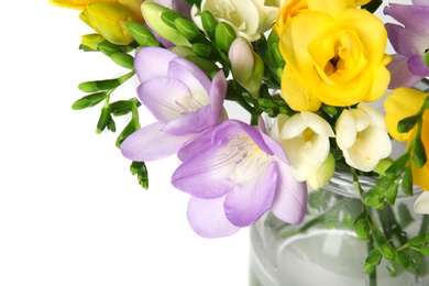 Bouquet of fresh freesia flowers in vase on white background, closeup