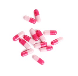 Photo of Many pink pills isolated on white, top view