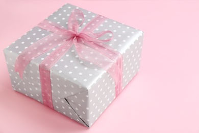 Photo of Beautifully decorated gift box on color background