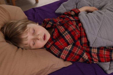 Photo of Little boy snoring while sleeping in bed